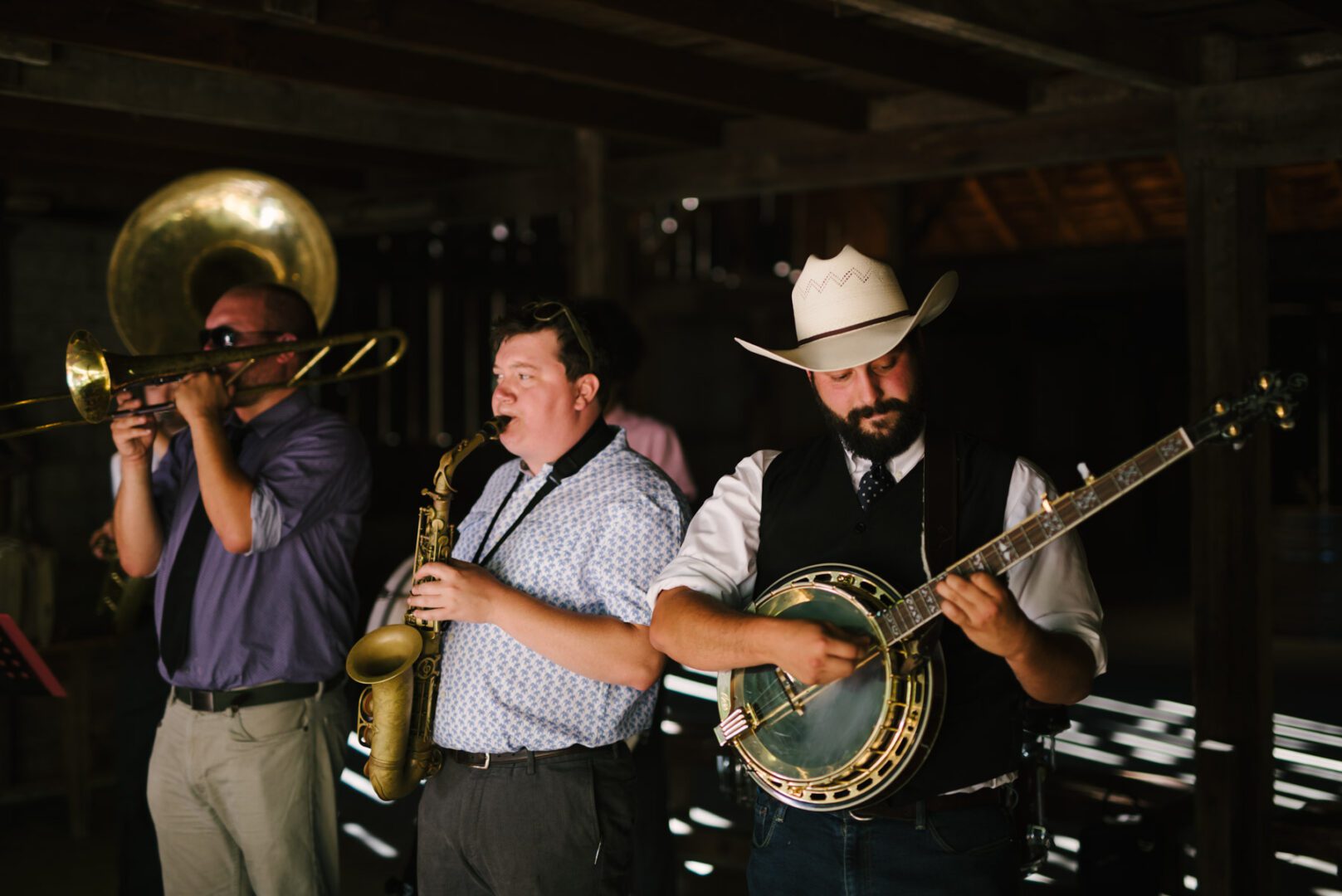 A group of men playing instruments in a barn.