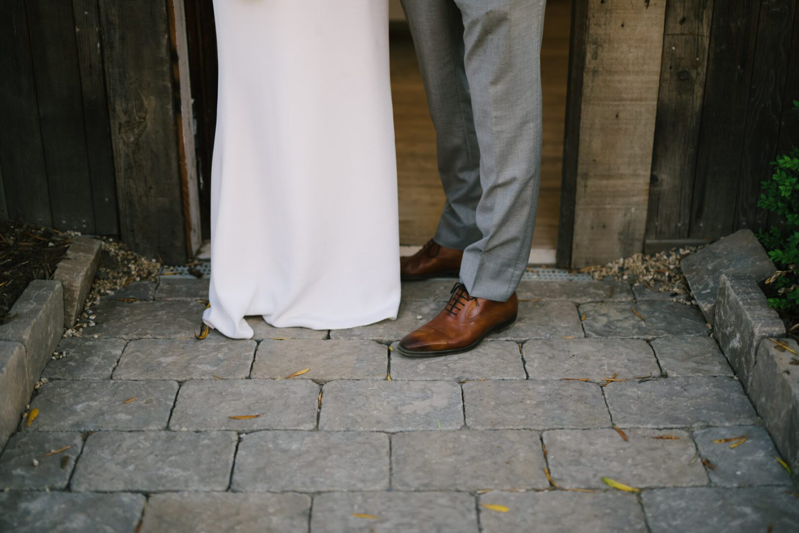 A bride and groom standing in front of a door.