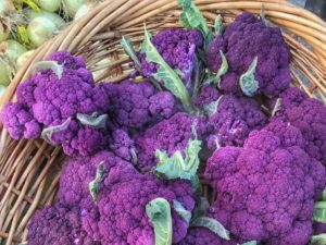 Purple cauliflower in a wicker basket.