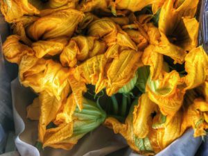 A bunch of yellow flowers in a paper bag.