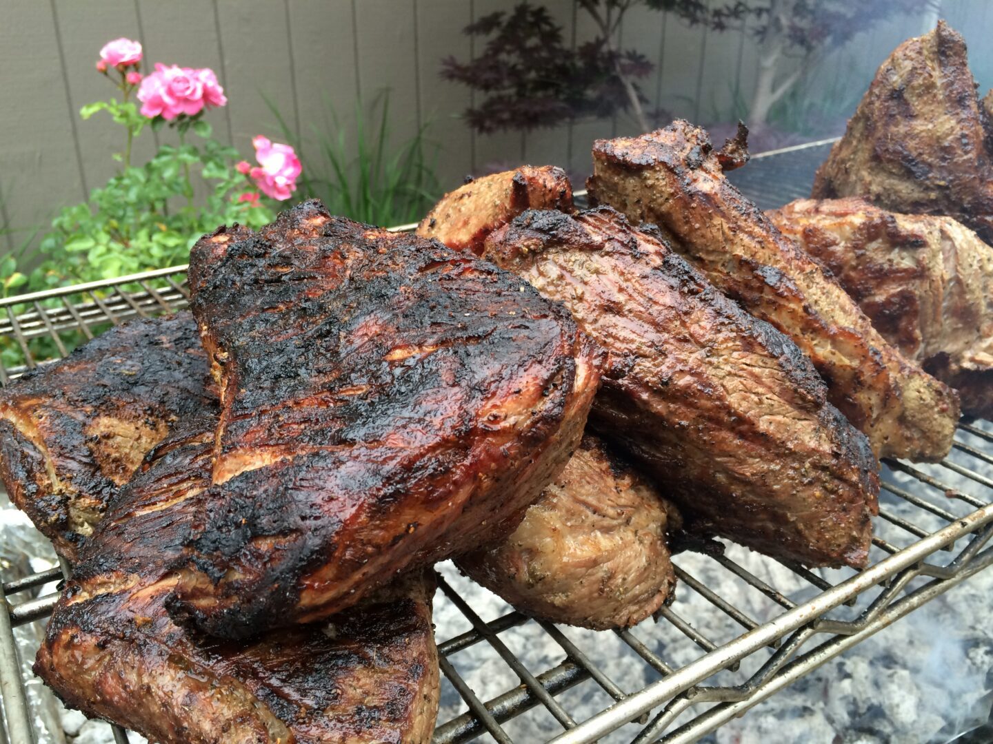 A grill with a lot of meat on it.