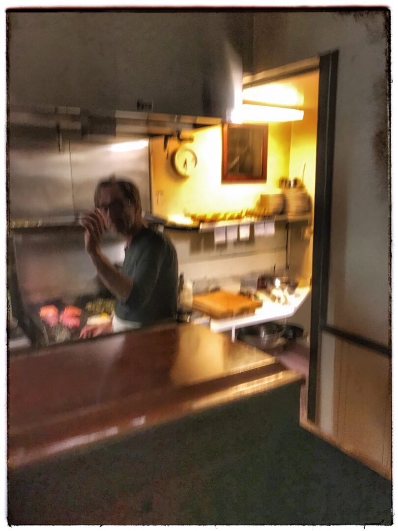 A man is cooking in a kitchen.