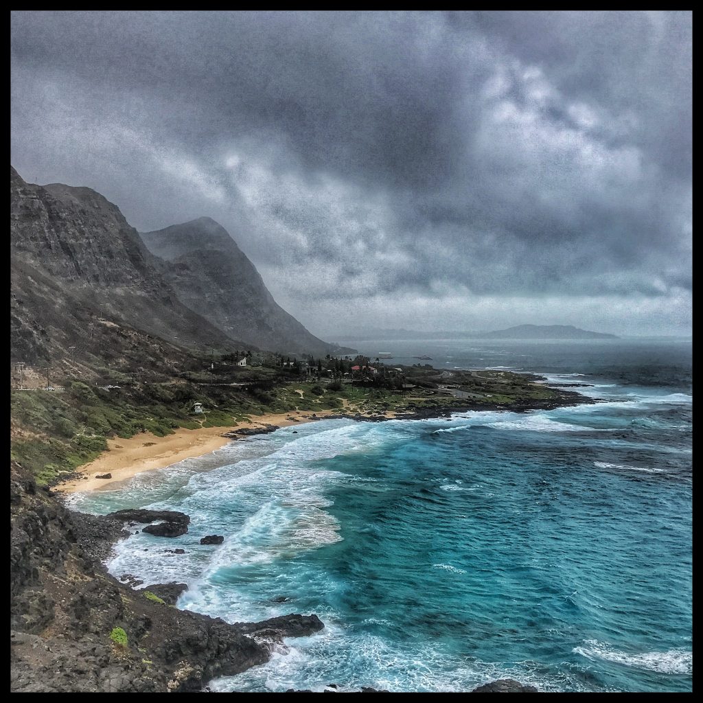 A view of a beach under a cloudy sky.