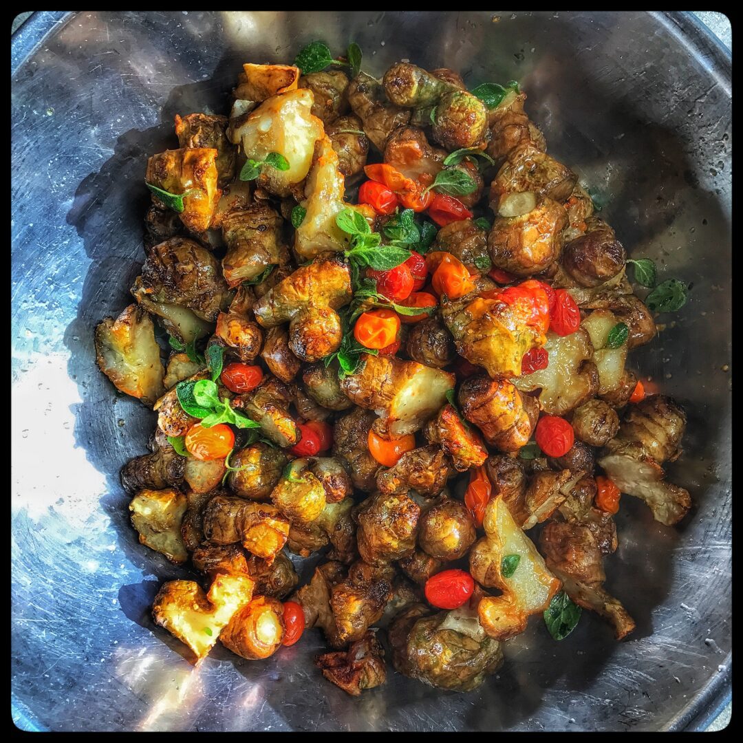 A bowl of roasted cauliflower and carrots.