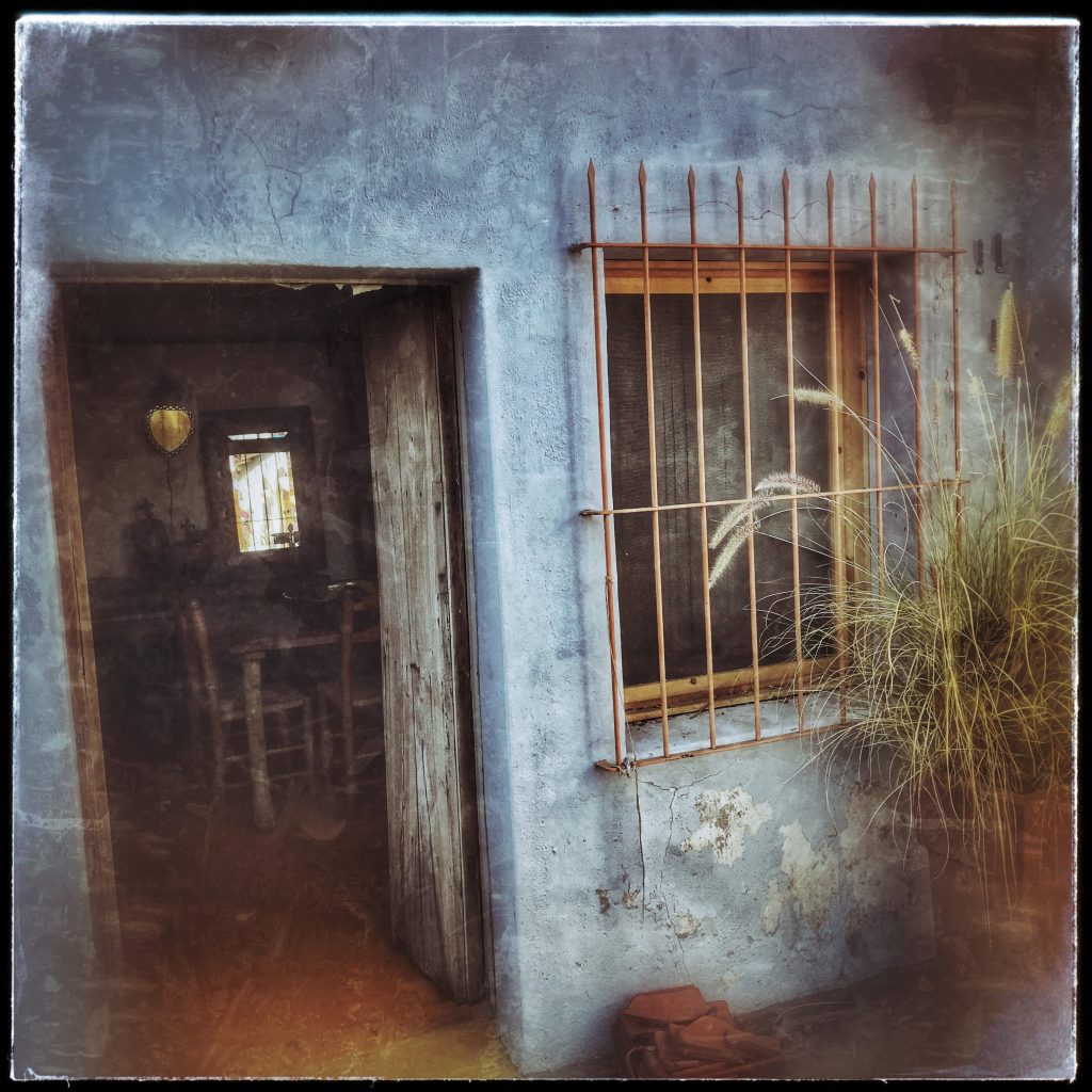 A blue doorway with bars on it.