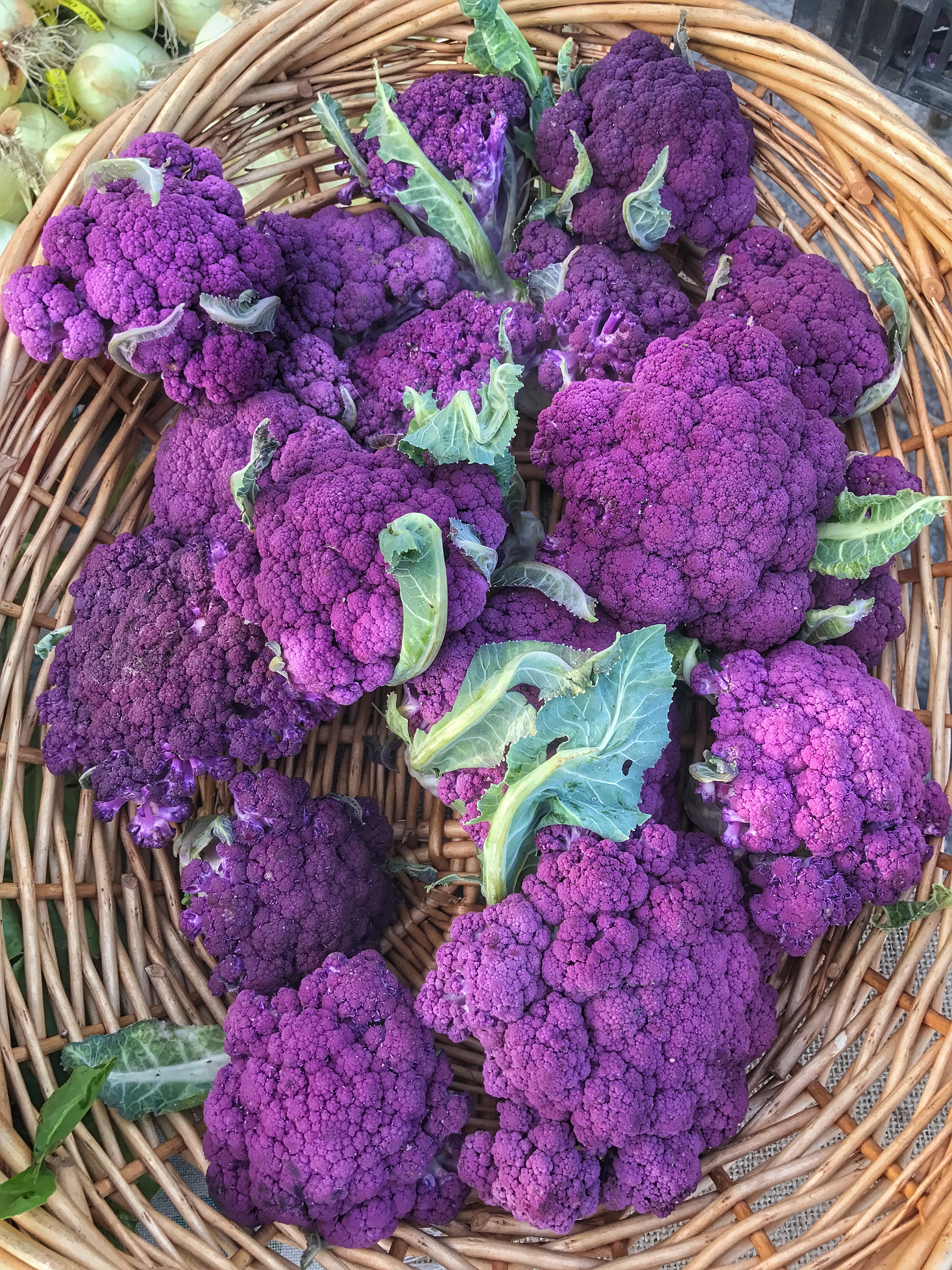 Purple cauliflower in a wicker basket.