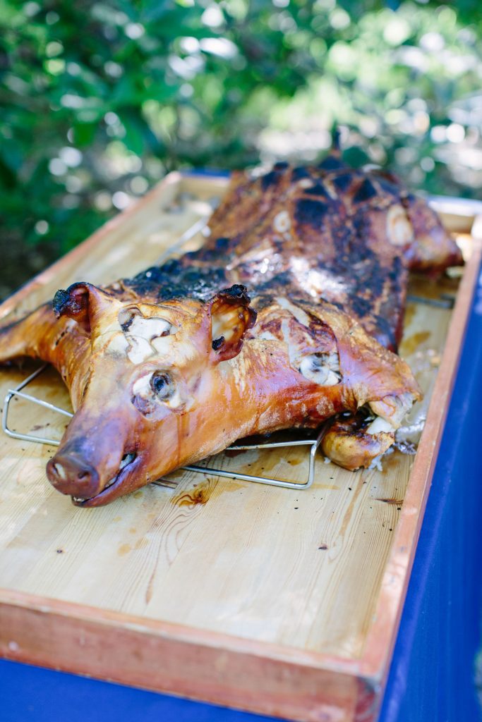 A roasted pig on a wooden board.