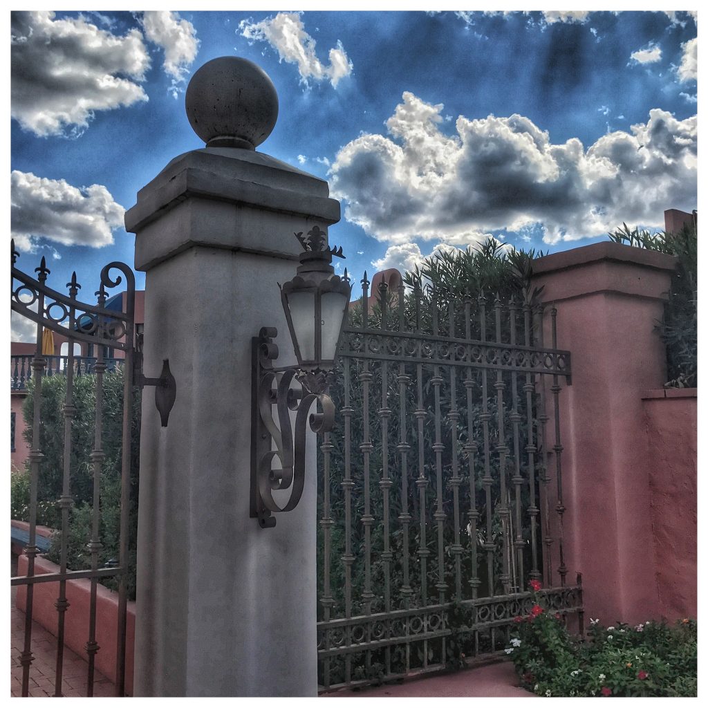 An iron gate with a light on it.