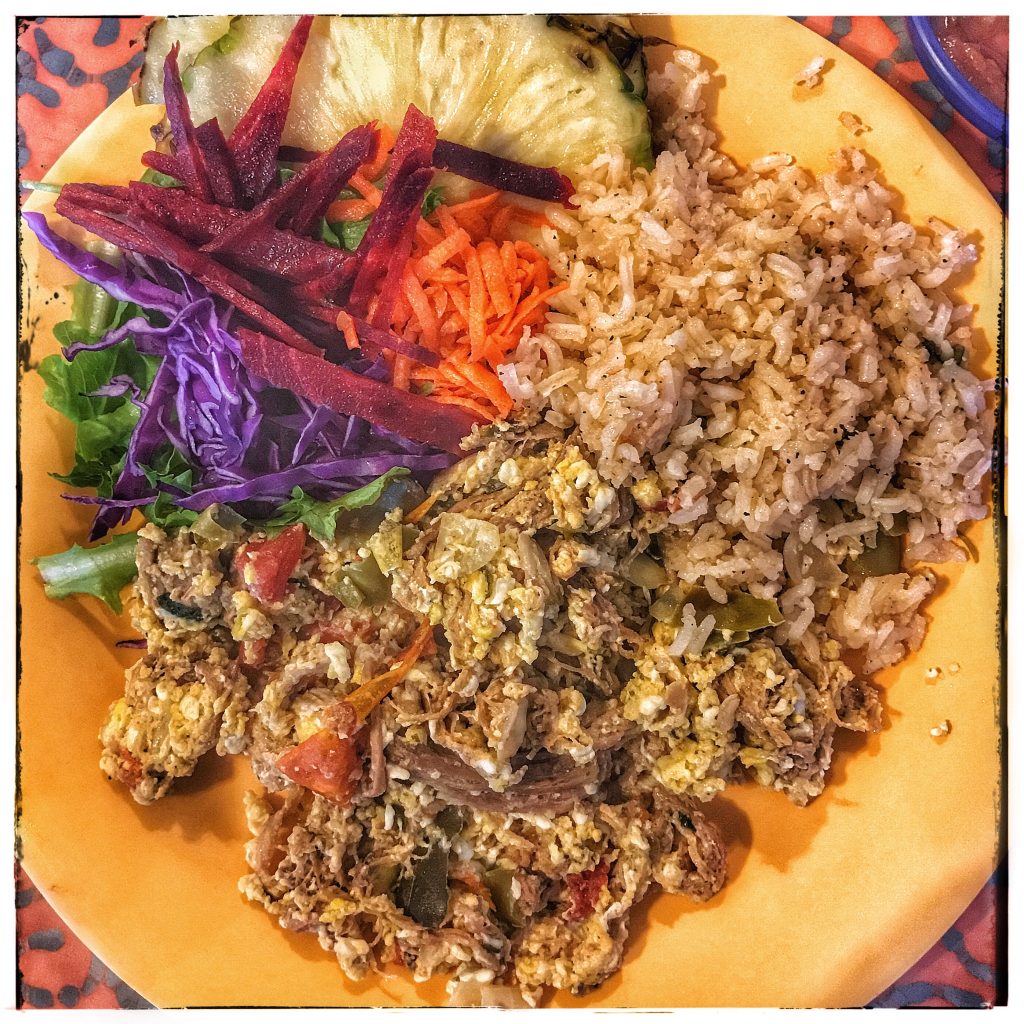 A plate of food with rice and vegetables on it.