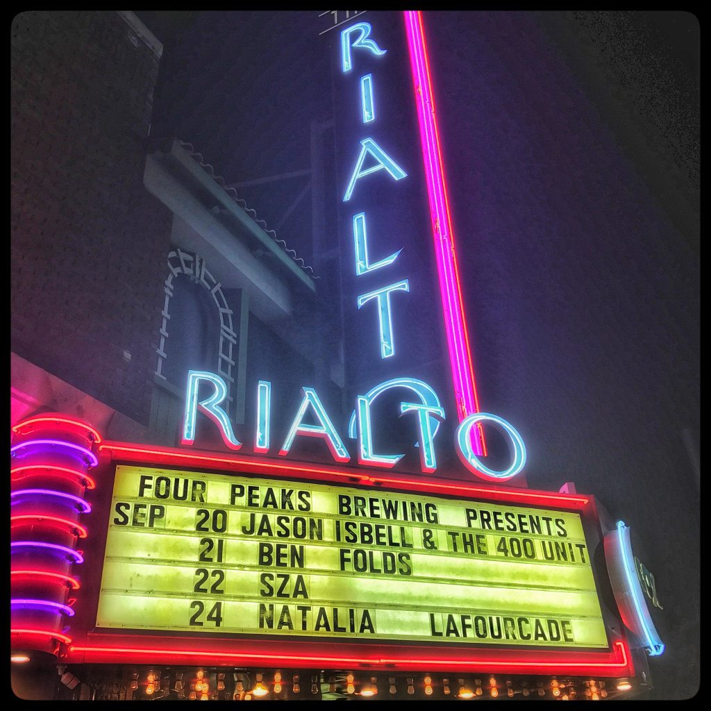 A neon sign with the words riato on it.