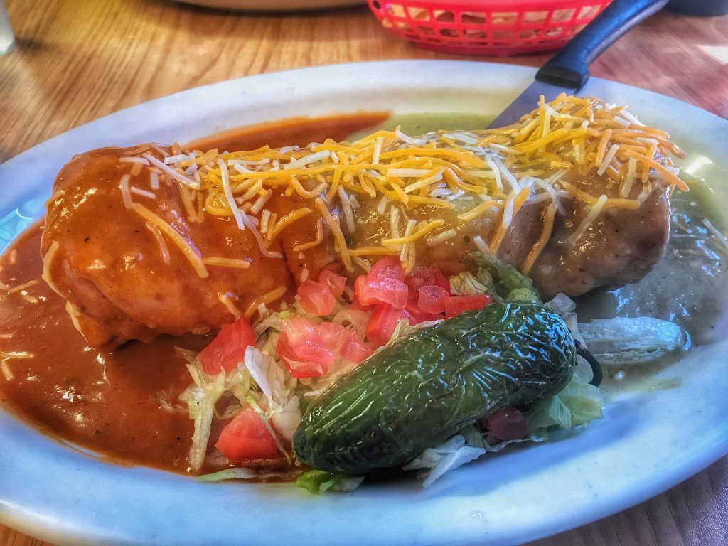 A plate with a burrito on it.