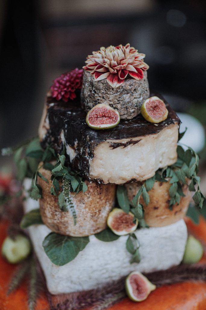 A cheese cake with figs and figs on top.