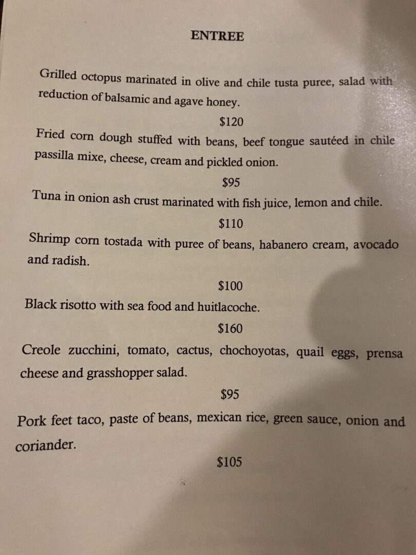 A menu for a restaurant with prices on it.