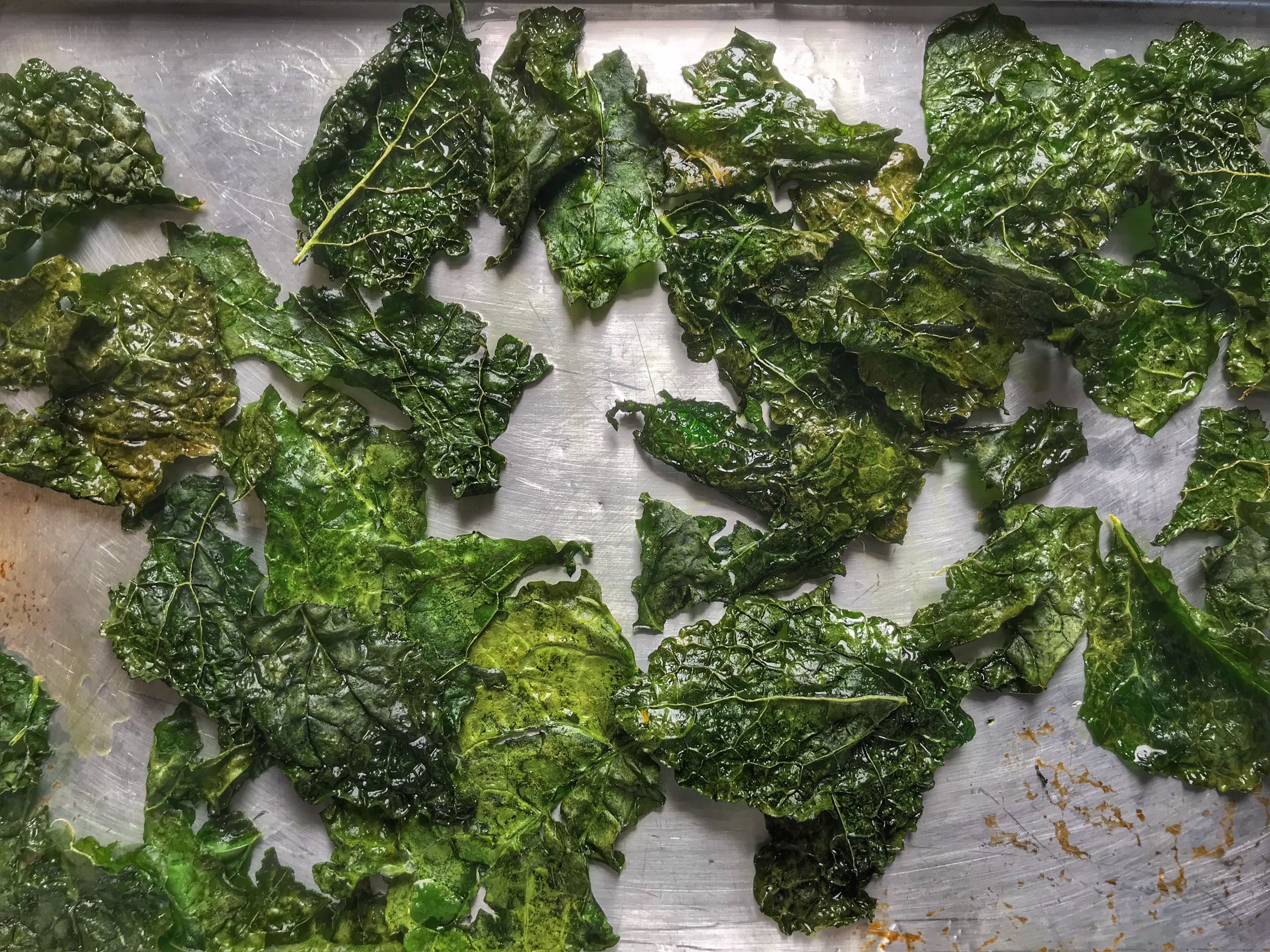 Kale chips on a baking sheet.