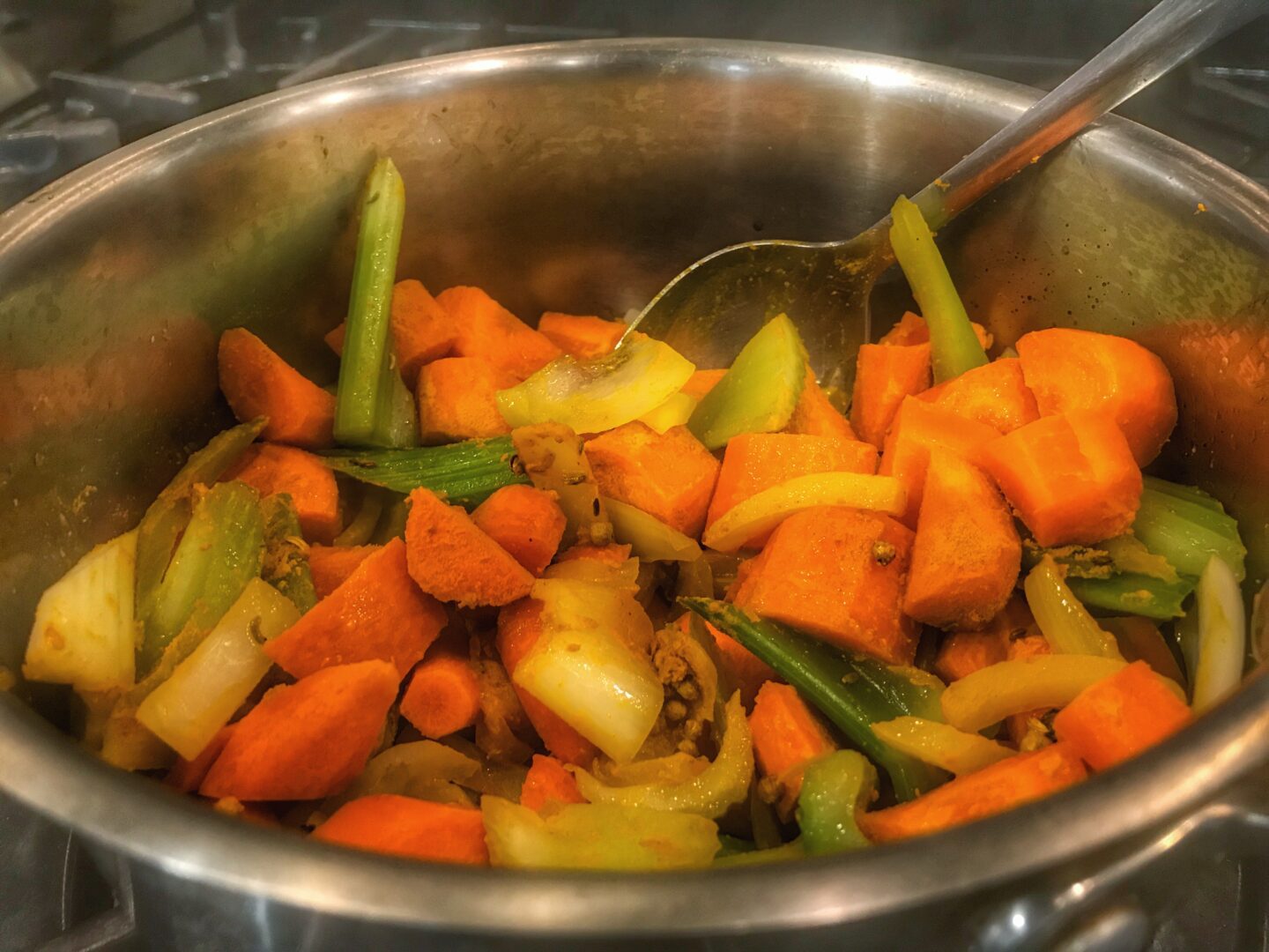 A pot of vegetables on a stove.