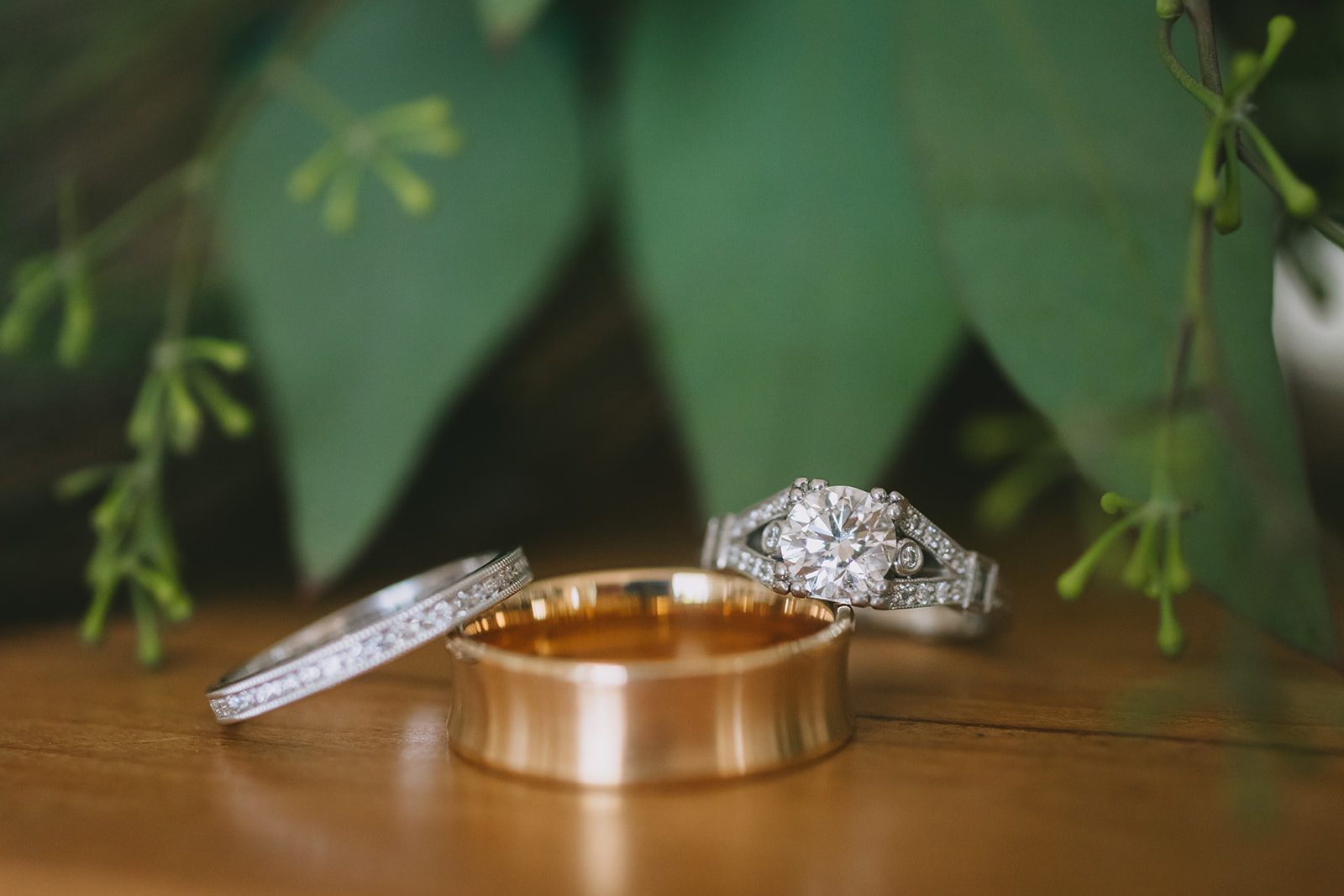 Two wedding rings on top of a wooden table.