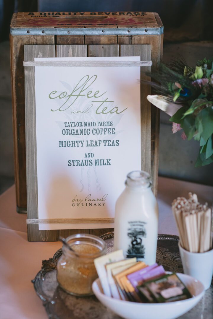 A coffee and tea sign on a table.