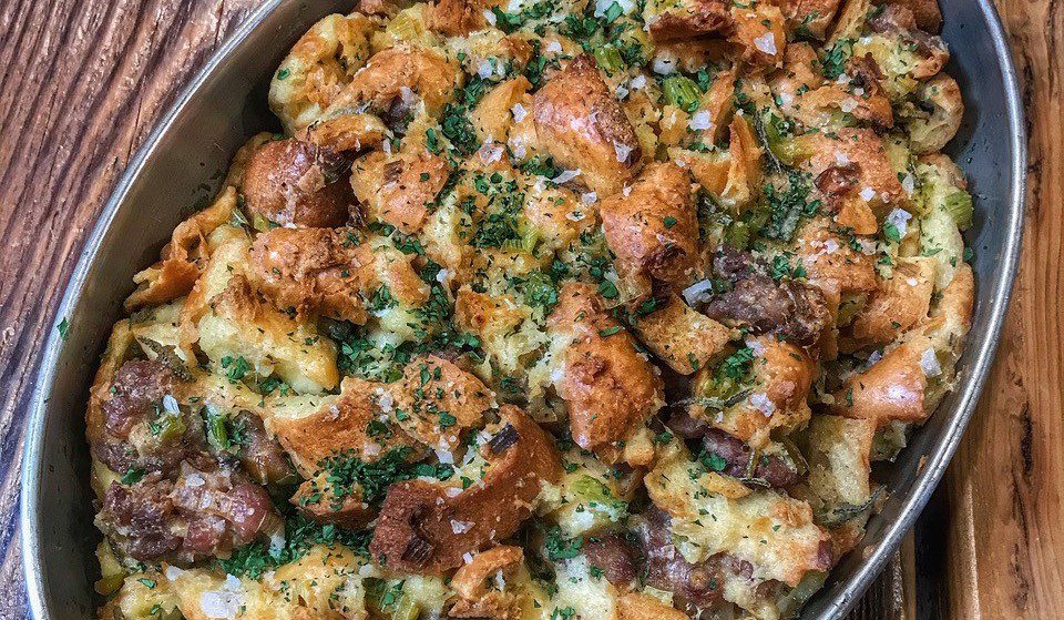 Thanksgiving-Style Sausage Stuffing Displayed on a Rustic Wooden Table.