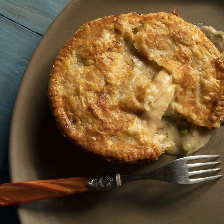 Chicken pot pie on a plate with a fork, featuring the Press Democrat's article.