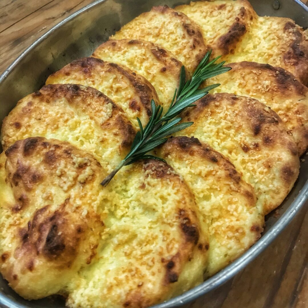 A baking dish with a rosemary sprig on top.