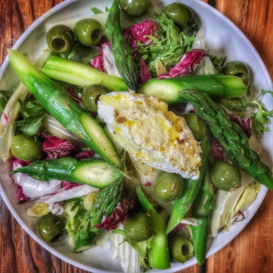 Asparagus salad with goat cheese and olives.