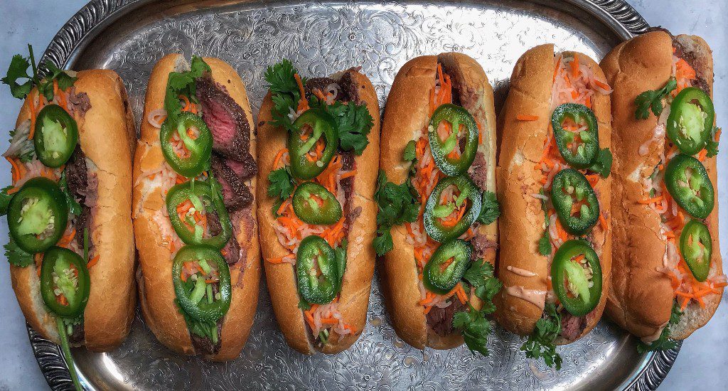 Vietnamese hot dogs on a silver tray.