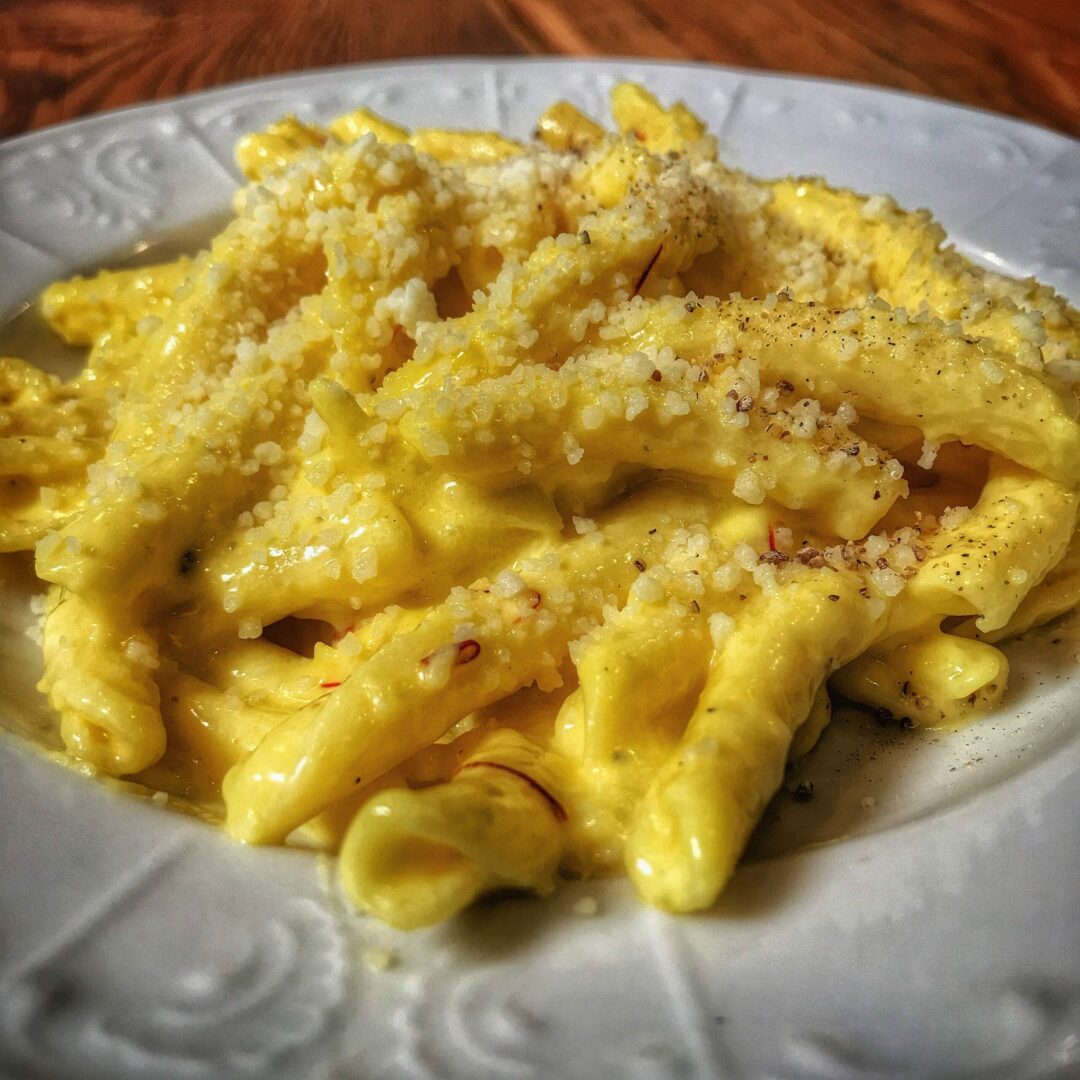 A plate of pasta with cheese and parmesan.
