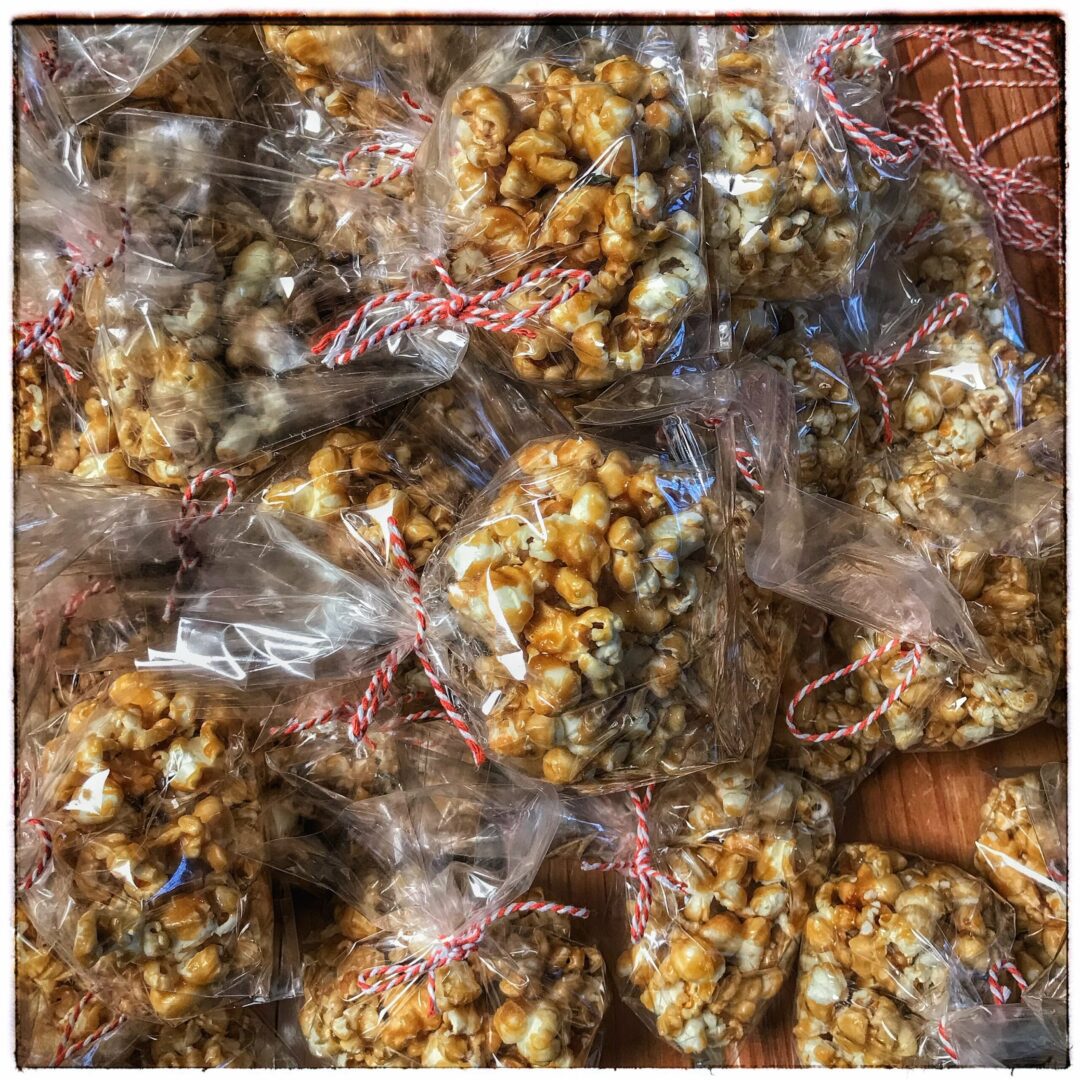 A bag of caramel popcorn sitting on a table.