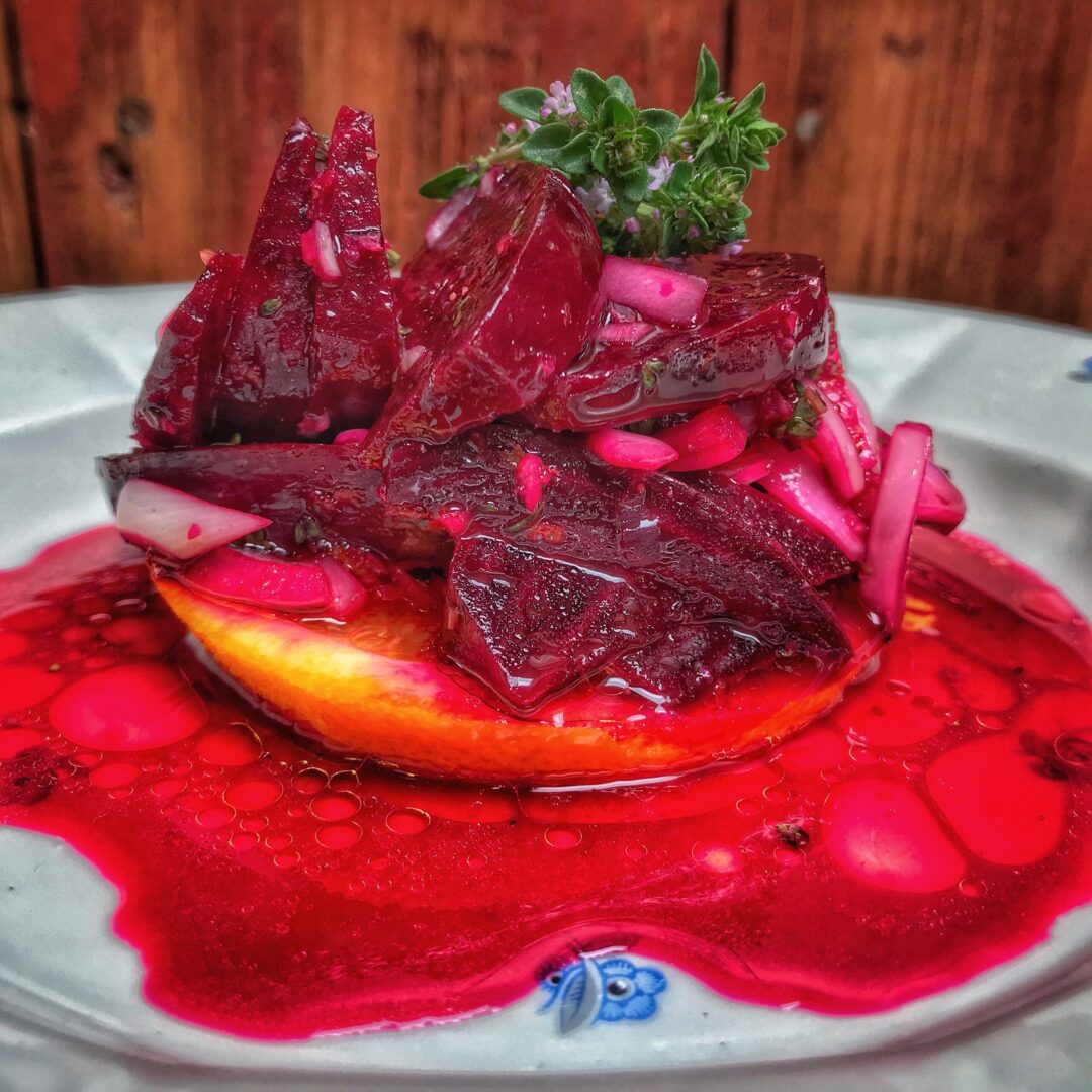 A plate with beets and sauce on it.