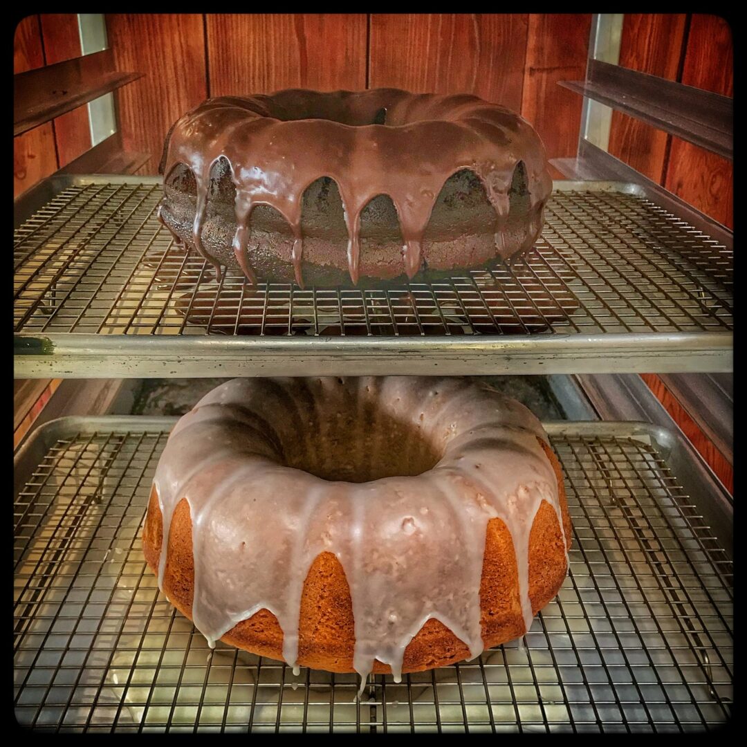 Two cakes on a rack.