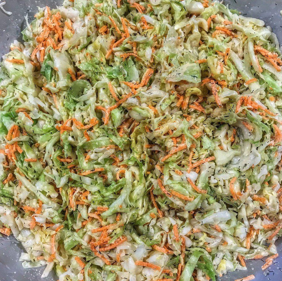 Shredded cabbage and carrots in a mixing bowl.
