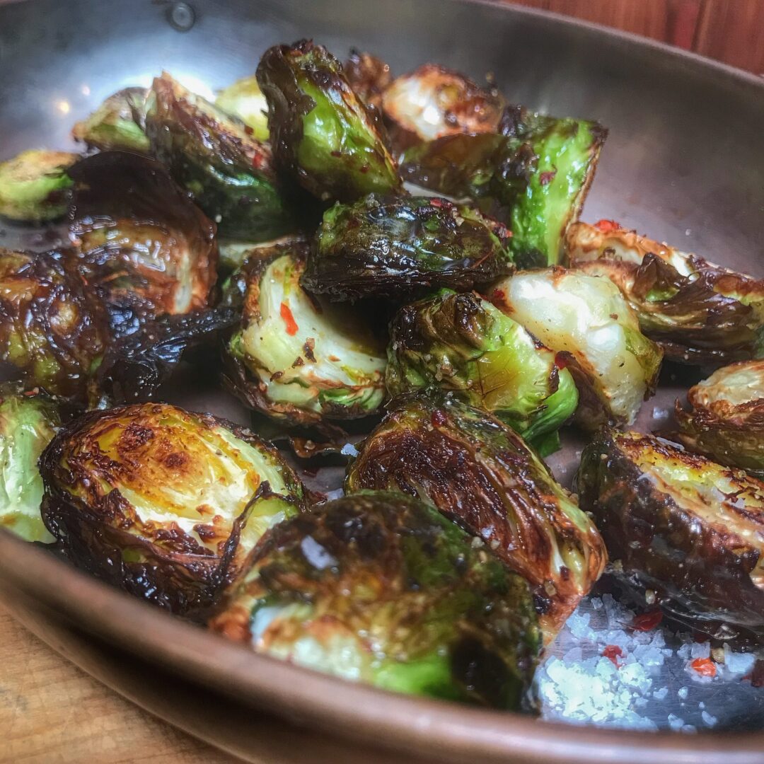 Gourmet roasted brussels sprouts in a skillet, perfect for those on the go.